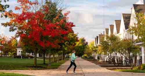 A contemporary image of a woman running through Laker Village